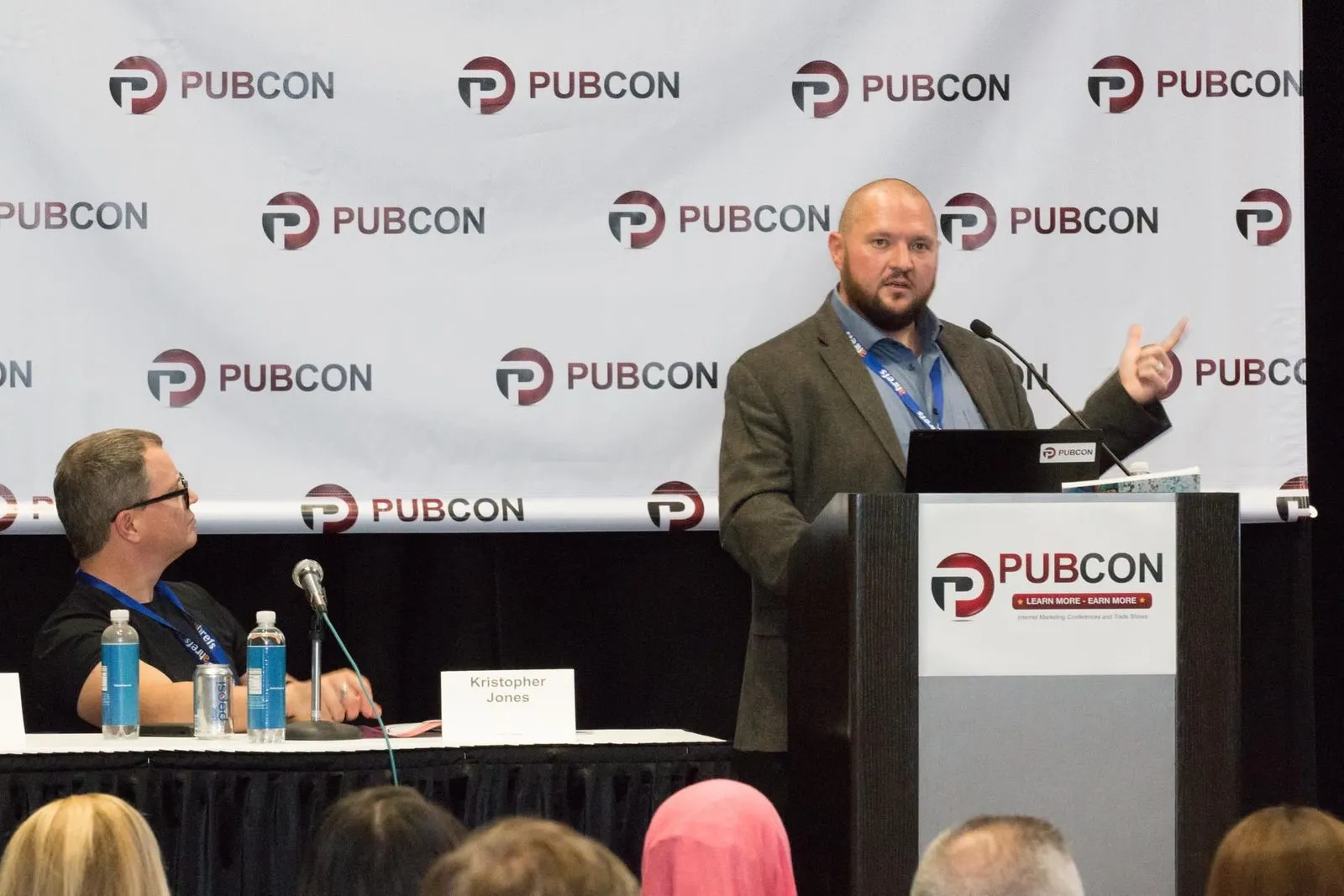 Bryant Garvin speaking at a Pubcon podium.