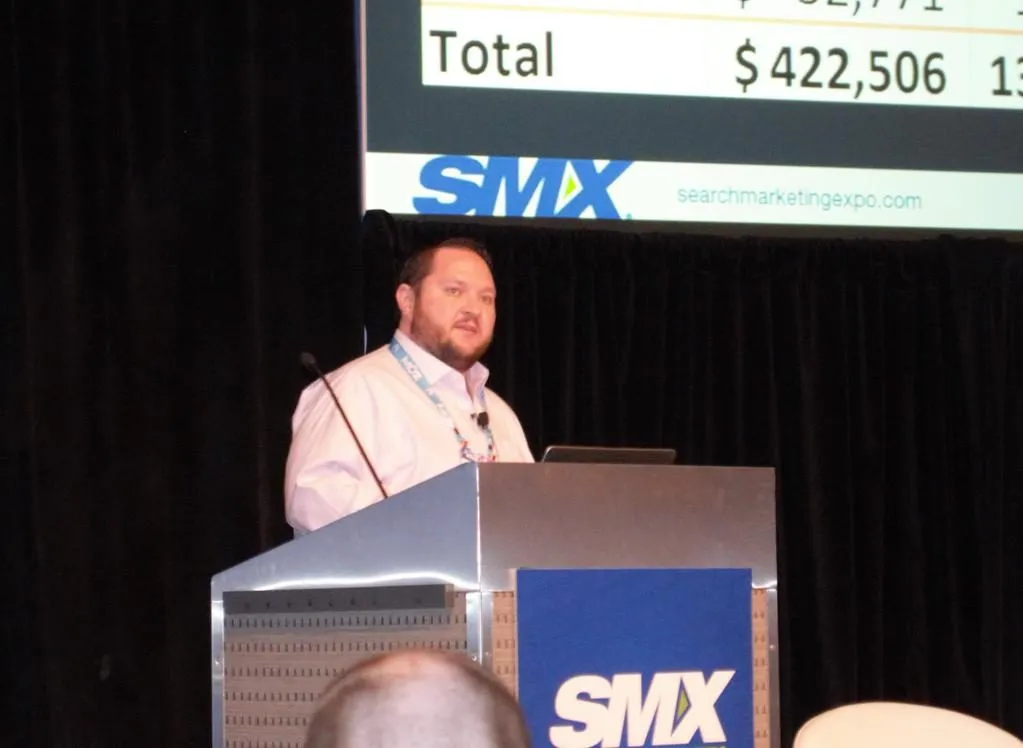 Bryant Garvin at an SMX podium in front of a slide of monthly totals.
