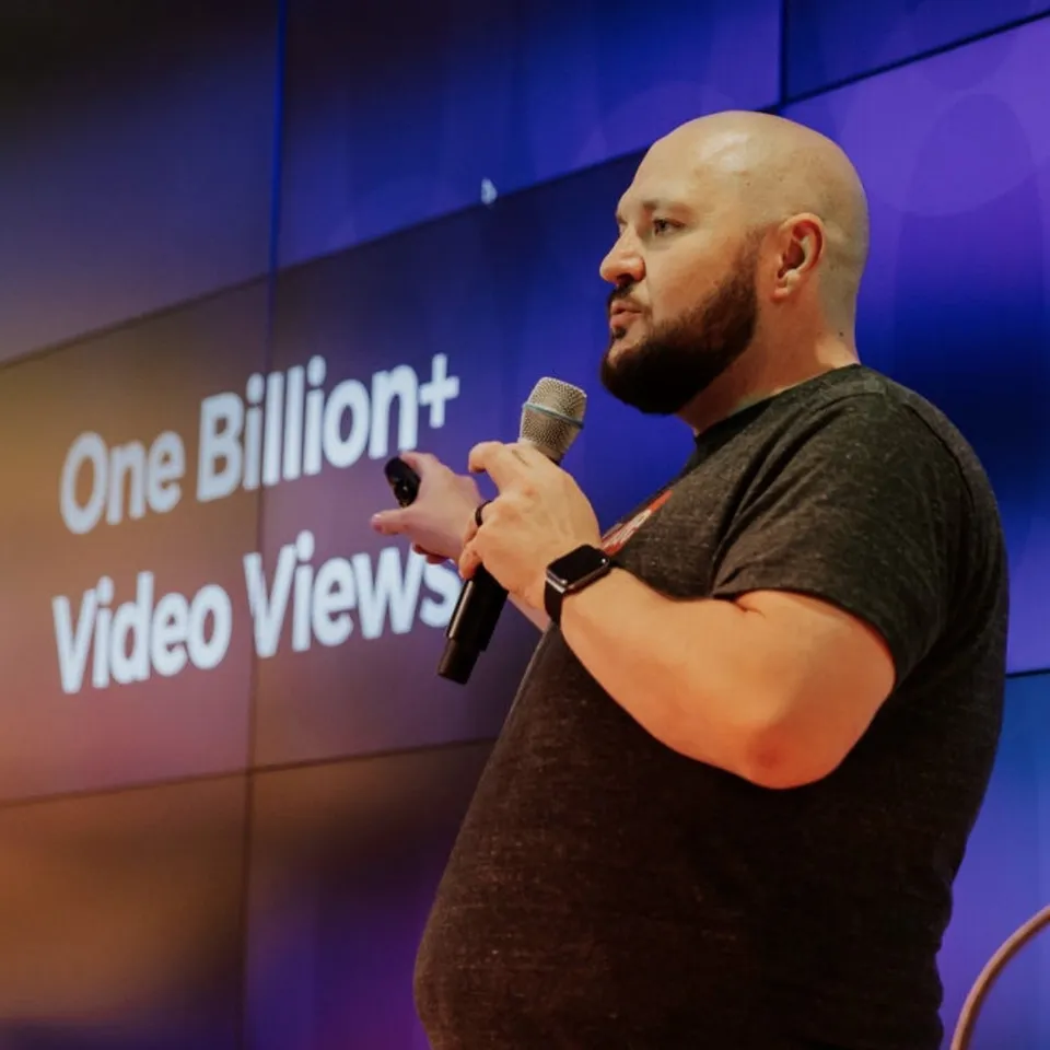 Bryant Garvin speaking on stage in front of a slide reading One Billion+ Video Views.