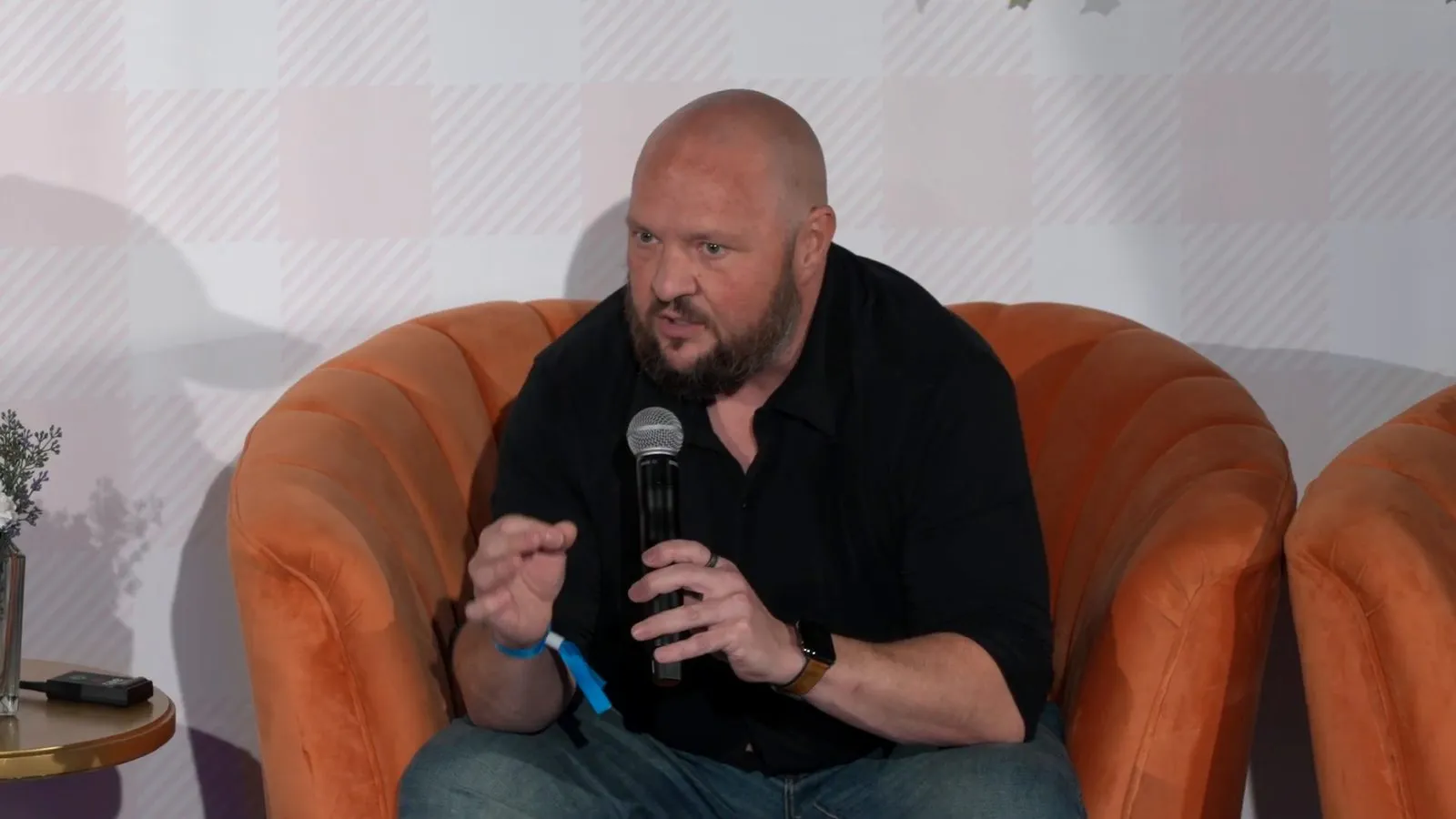 Bryant Garvin speaking into a microphone on the GROW NY stage.