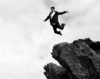 A person pushed to the edge of a cliff